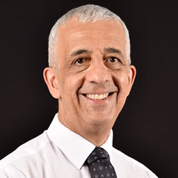 Head shot of Feridun Kadir wearing a white shirt an tie